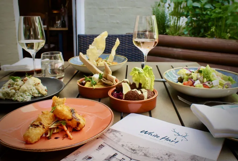 Small plates and wine on a table at the White Hart in Ironbridge